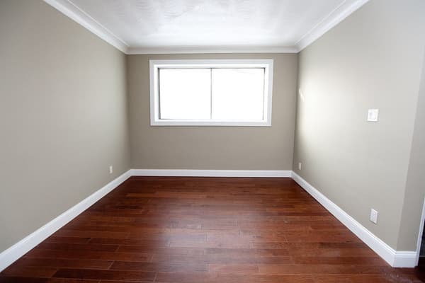 Bedroom with hardwood floors and a wide window at 18 Elm Street, Kingston