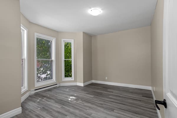 Bay window bedroom looking into the treetops at 203 Colborne Street, Kingston