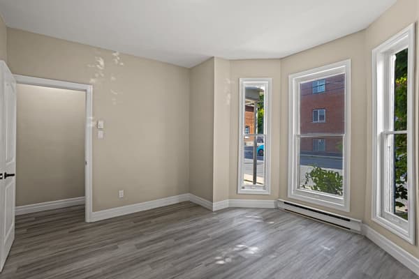 Corner bedroom with bay windows on two walls at 203 Colborne Street, Kingston