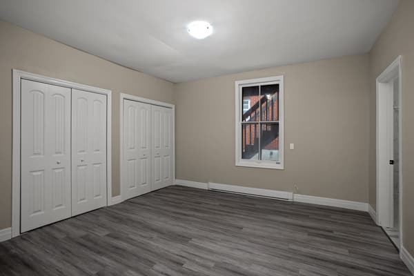 Bedroom with two double closets at 203 Colborne Street, Kingston
