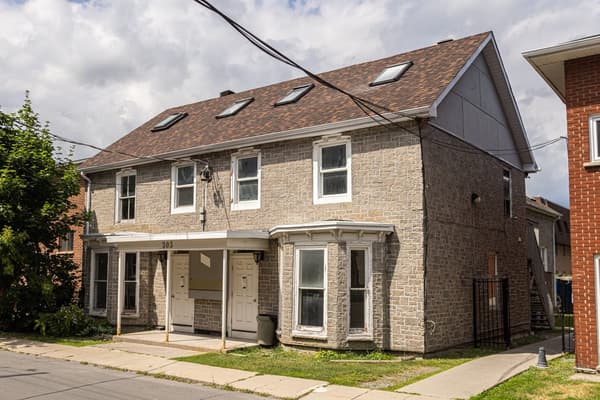 Stone exterior seen from the corner, with roof skylights at 203 Colborne Street, Kingston