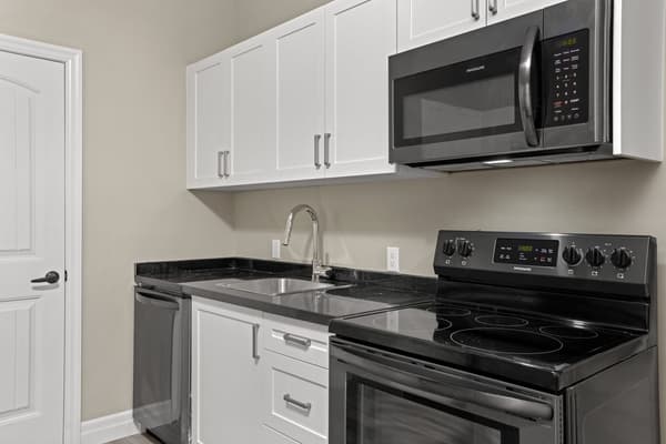 Kitchen counter, sink and range in close up at 203 Colborne Street, Kingston