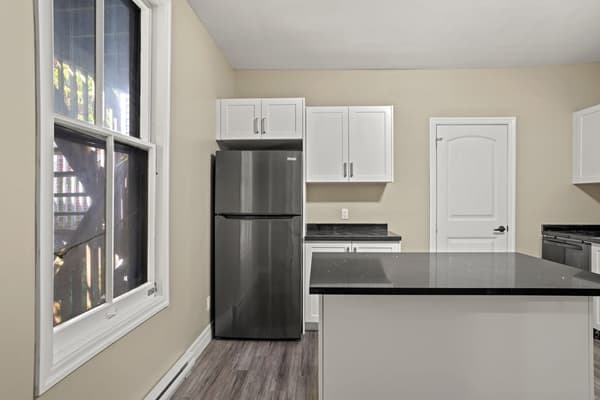 Kitchen with a stainless steel refrigerator and an island at 203 Colborne Street, Kingston
