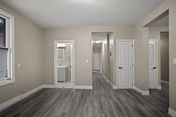 Living room with the bathroom and hallway beyond at 203 Colborne Street, Kingston