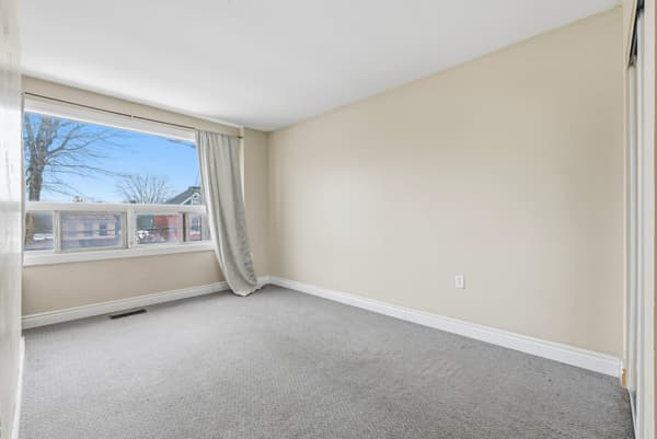 Carpeted bedroom with a wide window at 394 Alfred Street, Kingston