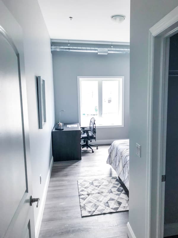Model suite bedroom with study desk and window at 630 Princess Street, Kingston