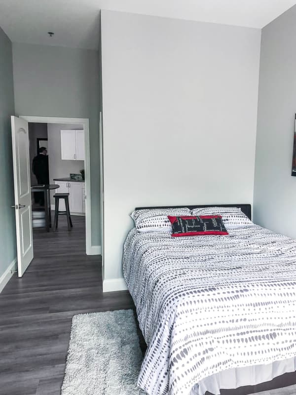 Model suite bedroom with view through to the kitchen at 630 Princess Street, Kingston